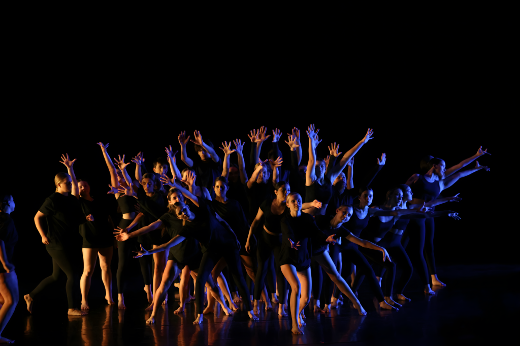 Dance performance on stage with lighting