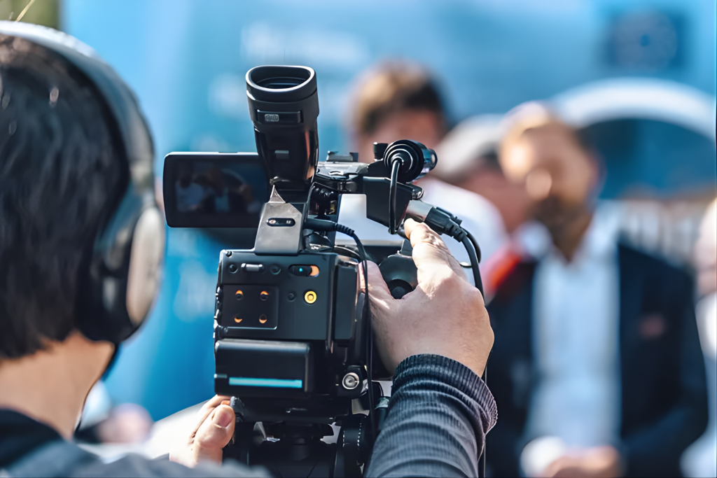 Camera crew filming a live broadcast at an event