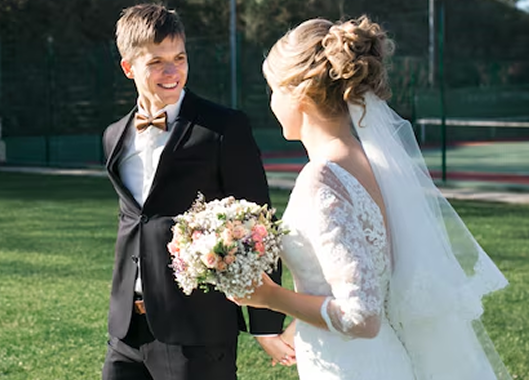 Bride and groom walking together in an outdoor wedding setting